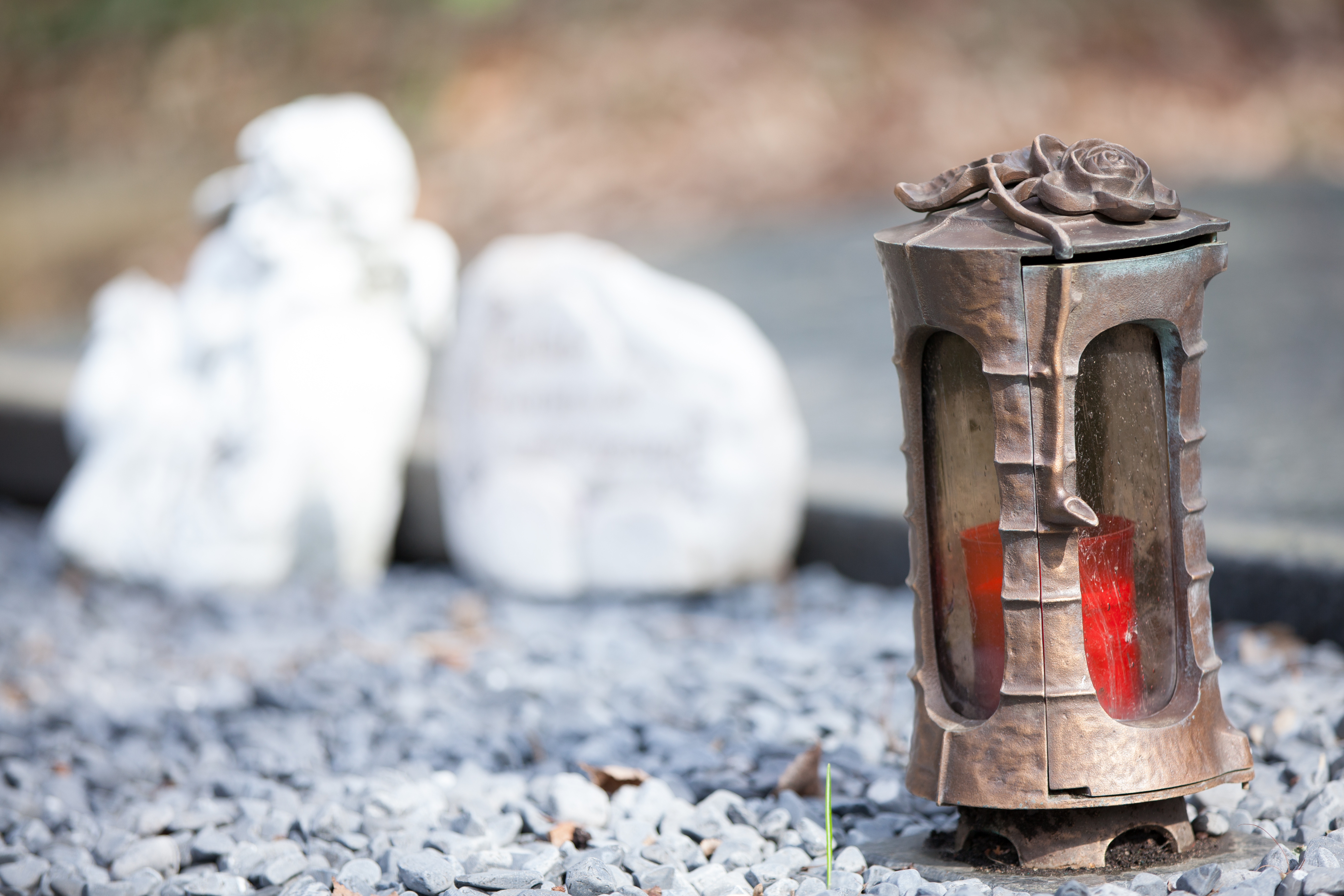 Eine Trauerkerze steht auf einem Grab